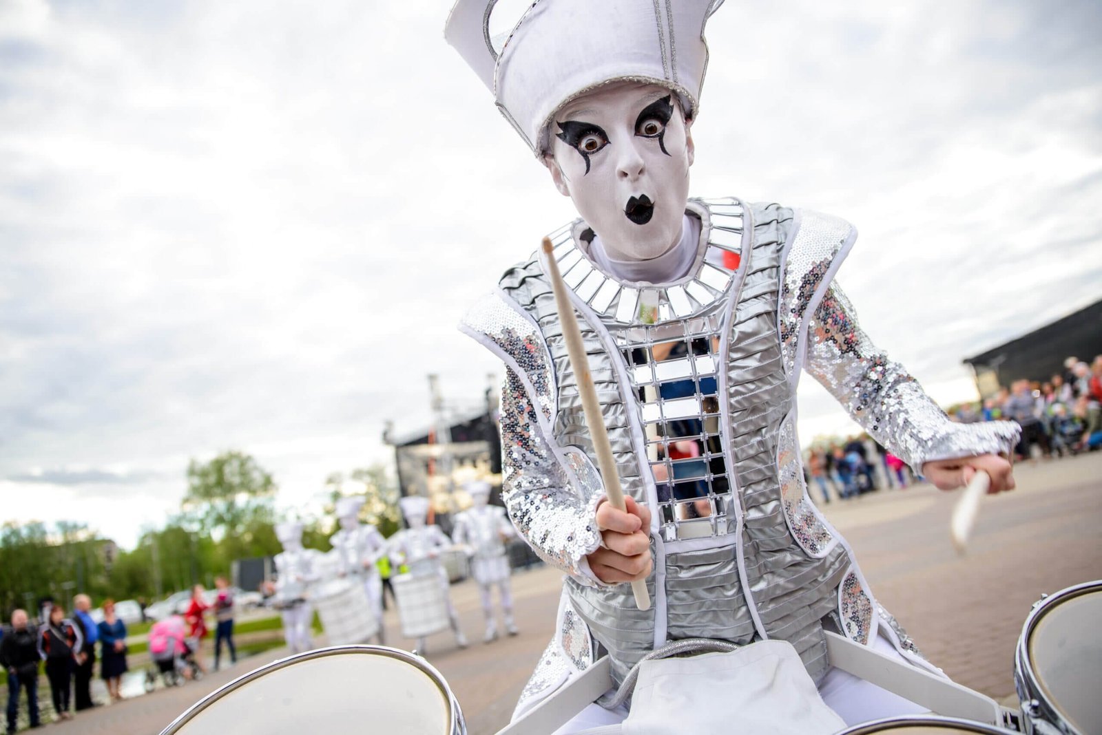 A Spark! performer in white and silver, wide-eyed mid-performance at a daytime show